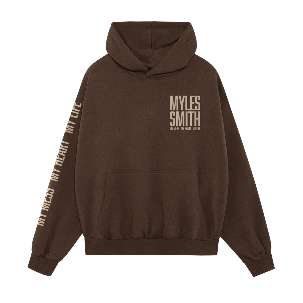 Front view of a Myles Smith Brown hoodie with ivory text on the right chest reading ‘Myles Smith My Mess, My Heart, My Life.’ and additional ivory text ‘My Mess, My Heart, My Life.’ printed along the right sleeve
