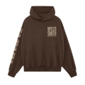 Front view of a Myles Smith Brown hoodie with ivory text on the right chest reading ‘Myles Smith My Mess, My Heart, My Life.’ and additional ivory text ‘My Mess, My Heart, My Life.’ printed along the right sleeve