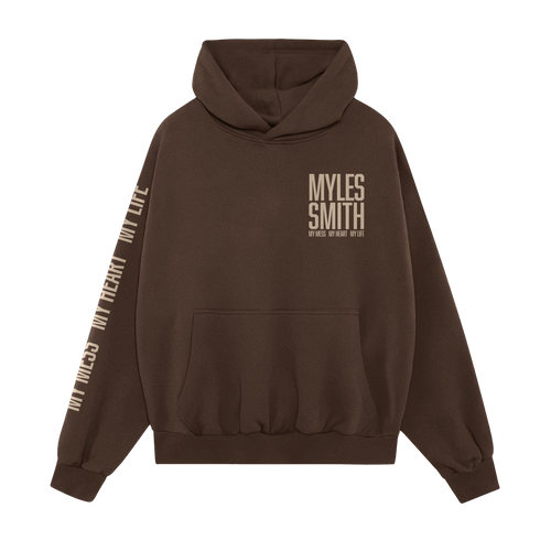 Front view of a Myles Smith Brown hoodie with ivory text on the right chest reading ‘Myles Smith My Mess, My Heart, My Life.’ and additional ivory text ‘My Mess, My Heart, My Life.’ printed along the right sleeve
